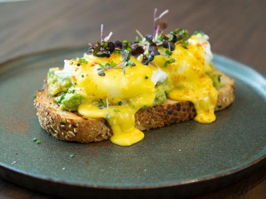 Guacamole with silky poached eggs and hollandaise sauce 