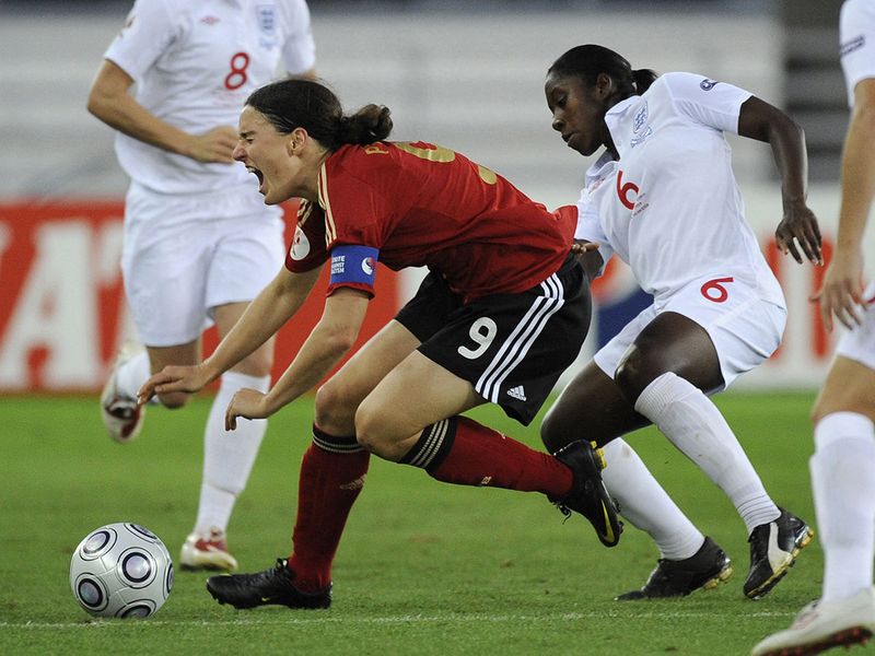 (FILES) This file photograph taken on September 10, 2009, shows Germany's Birgit Prinz (R) struggling for the ball with England's Anita Asante during the final of the Women's EURO 2009 Germany vs England, at the Olympic Stadium in Helsinki. 