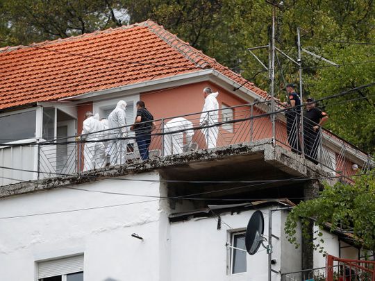 Police forensic team inspect the house where a gunman started a mass shooting in which 12 people, including the gunman, were killed, according to local media reports, in Cetinje, Montenegro on August 12, 2022. 