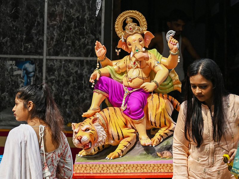 Devotees prepare to carry an idol of the deity Ganesha on the first day of ten-day 'Ganesh Chaturthi' festival in Mumbai. 