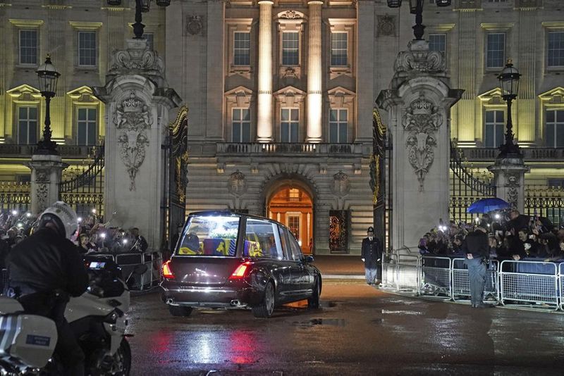 The hearse carrying the coffin of Queen Elizabeth II arrives at Buckingham Palace, London, Tuesday, Sept. 13, 2022, from where it will rest overnight in the Bow Room.  