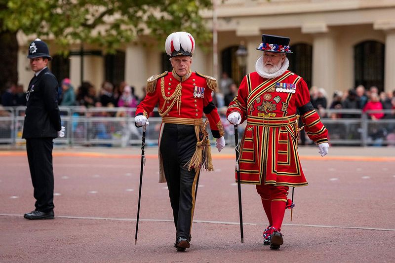 A Yeomen of the Guard, right, and Gentlemen at Arms members take positions ahead of the Queen Elizabeth II funeral in central London, Monday, Sept. 19, 2022. The Queen, who died aged 96 on Sept. 8, will be buried at Windsor alongside her late husband, Prince Philip, who died last year. 