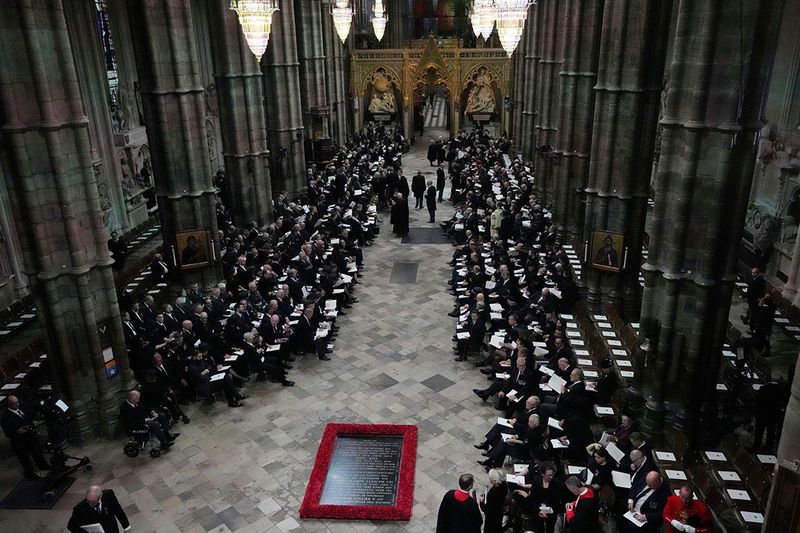 Guests and officials begin to take their places prior to the coffin of Queen Elizabeth II being carried into Westminster Abbey for her funeral in central London, Monday, Sept. 19, 2022. The Queen, who died aged 96 on Sept. 8, will be buried at Windsor alongside her late husband, Prince Philip, who died last year. 