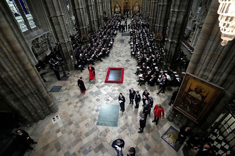 Guests and officials begin to take their places prior to the funeral service of Queen Elizabeth II at Westminster Abbey in central London, Monday, Sept. 19, 2022. The Queen, who died aged 96 on Sept. 8, will be buried at Windsor alongside her late husband, Prince Philip, who died last year.    
