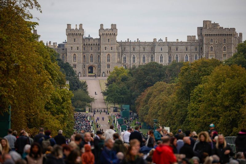 Spectators line the Long Walk at Windsor Castle ahead of the state funeral of Queen Elizabeth II, in Windsor, UK, on Monday, Sept. 19, 2022. The Queen's life is commemorated at her state funeral in Westminster Abbey in London, to be attended by roughly 500 global dignitaries and world leaders including US President Joe Biden. 