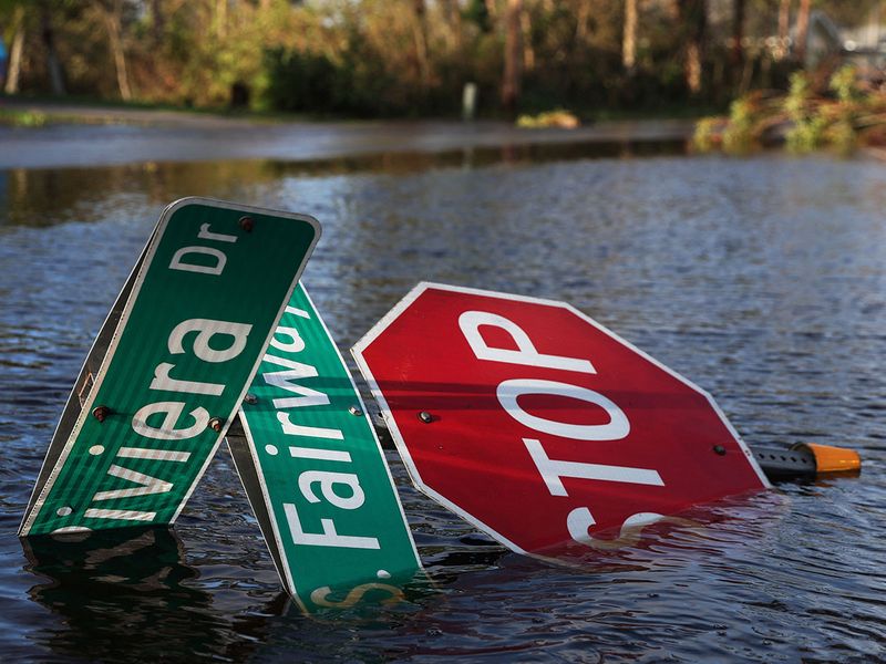 A street sign lies in flood waters after Hurricane Ian made landfall in southwestern Florida, in Punta Gorda, Florida, U.S., September 29, 2022. REUTERS/Shannon Stapleton