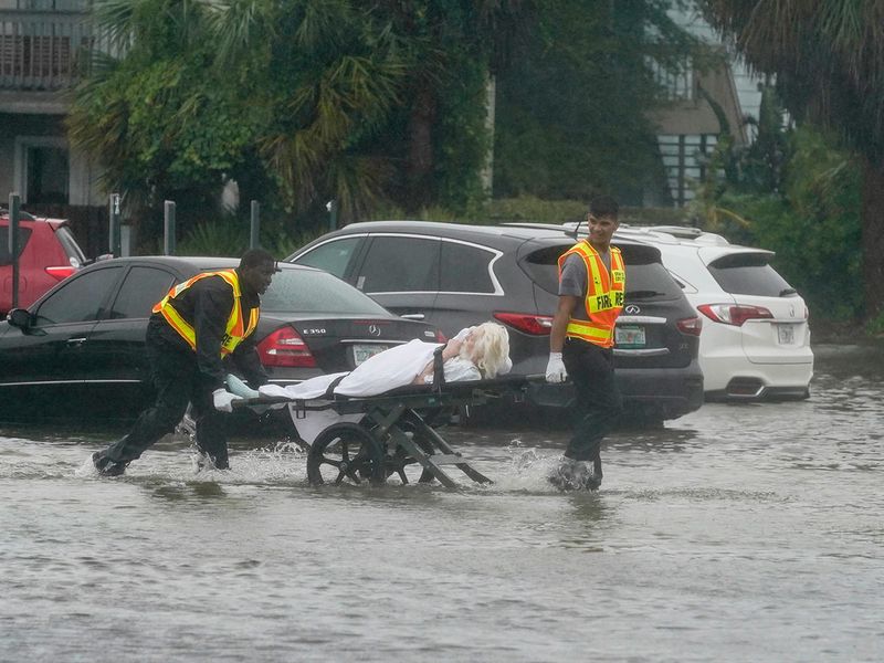 Authorities transport a person out of the Avante nursing home in the aftermath of Hurricane Ian, Thursday, Sept. 29, 2022, in Orlando, Fla. Hurricane Ian carved a path of destruction across Florida, trapping people in flooded homes, cutting off the only bridge to a barrier island, destroying a historic waterfront pier and knocking out power to 2.5 million people as it dumped rain over a huge area on Thursday. (AP Photo/John Raoux)