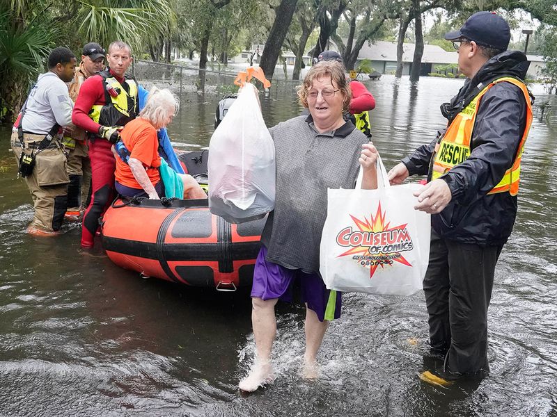 Residents are rescued from floodwaters in the aftermath of Hurricane Ian in Orlando, Fla., on Thursday, Sept. 29, 2022. (AP Photo/John Raoux)