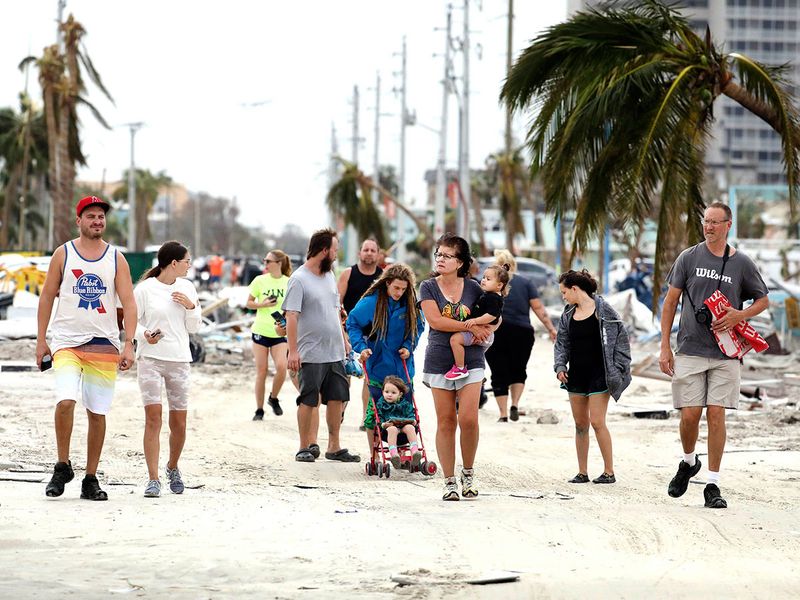 Residents explore damage in Fort Myers Beach, Fla., on Thursday, Sep 29, 2022, following Hurricane Ian. 