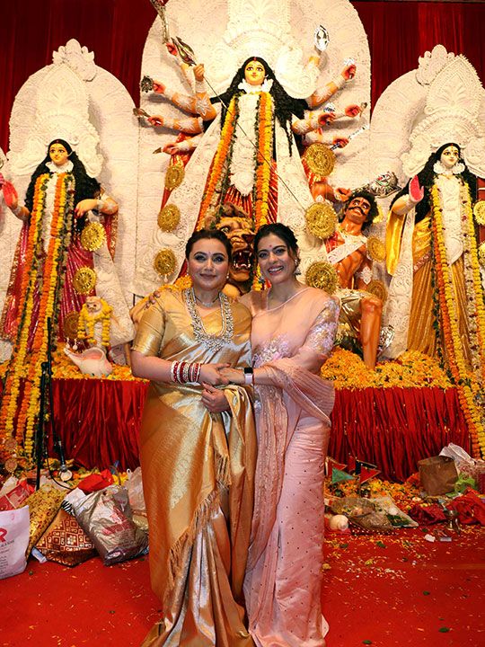 Bollywood actresses Rani Mukherjee Chopra and Kajol pose for a picture in front of the the Durga Puja festival celebrations, in Mumbai on Monday.