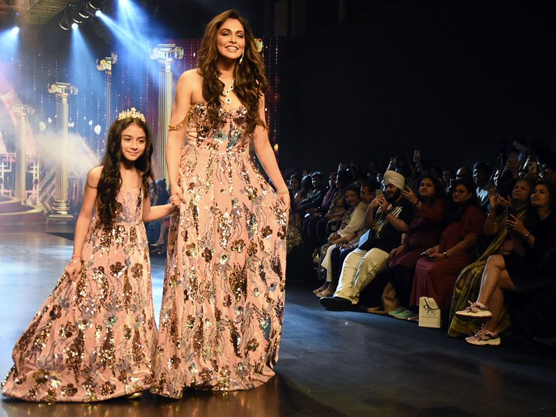 Isha Koppikar Narang with her daughter Rianna Narang walks the ramp while showcasing the collection of designer SR Queens on the second day of the Bombay Times Fashion Week 2022, at St. Regis, in Mumbai on Saturday. (ANI Photo)
