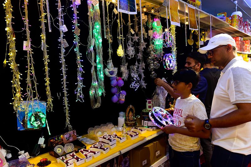 Residents buying decorative lights for Diwali celebrations at Madhoor supermarket in Karama.