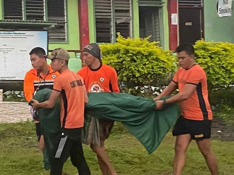 Philippine Coast Guard (PCG) rescuers carry a retrieved body, in Datu Odin Sinsuat, Maguindanao. 