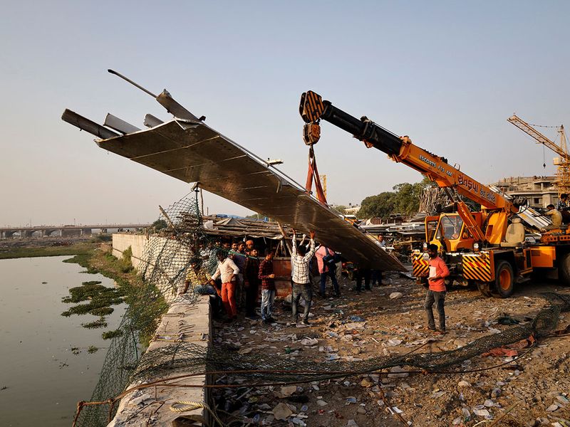 Photos: Families Line Up To Bury Dead From India Bridge Collapse | News ...