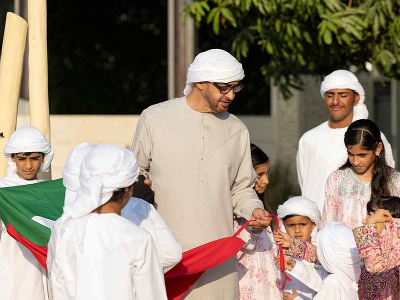 President His Highness Sheikh Mohamed bin Zayed Al Nahyan with his grandchildren ahead of hoisting the UAE flag at the Sea Palace on the occasion of Flag Day.
