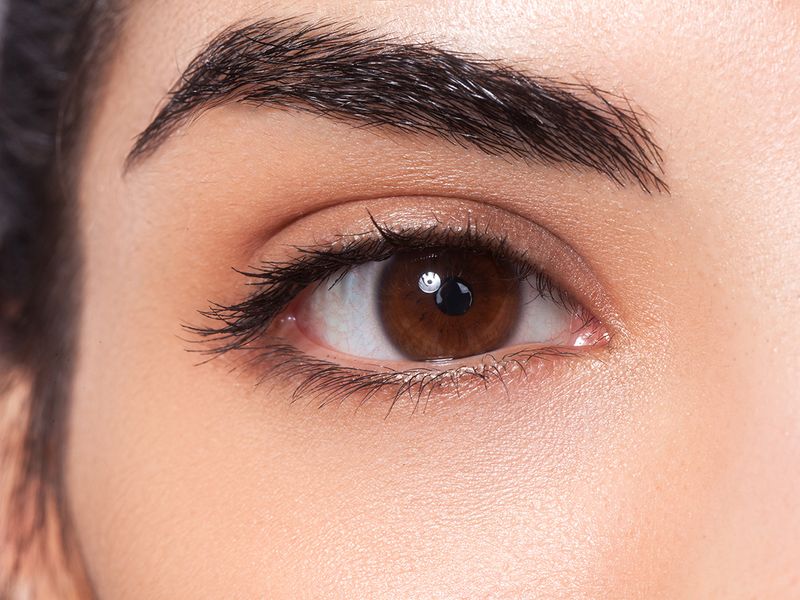Well-shaped eyebrow and brown eye with black eyeliner 