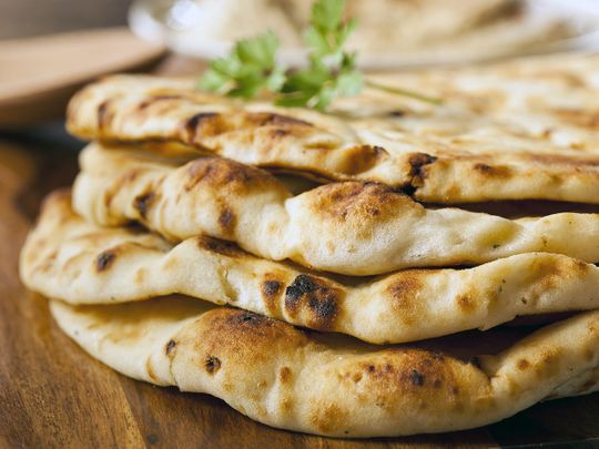 Four Naan garnished with coriander leaf