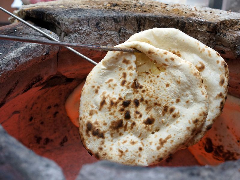 Freshly baked naan from a traditional clay oven  