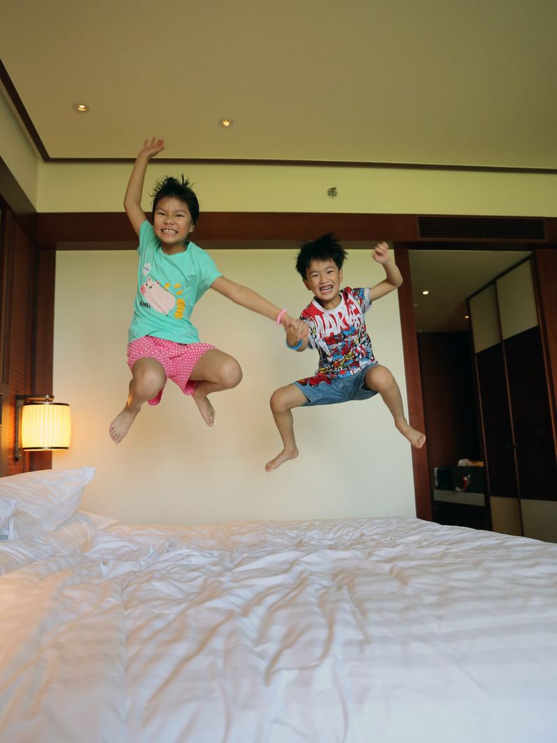 Children jumping on the bed