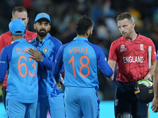 England's captain Jos Buttler (R) shakes hands with India's Virat Kohli