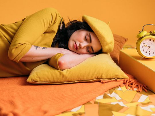 Woman in a yellow outfit taking a nap