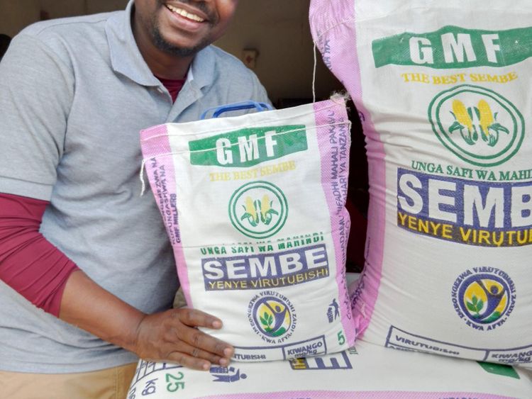 Dr. Nandonde, owner of GMF Mills, a university lecturer with a passion for flour processing, shows his customised pink flour bags from Sanku, in Morogoro, Tanzania, 2022.