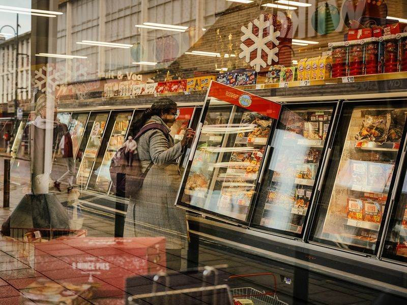 A customer browses the freezer section at a supermarket in Crawley