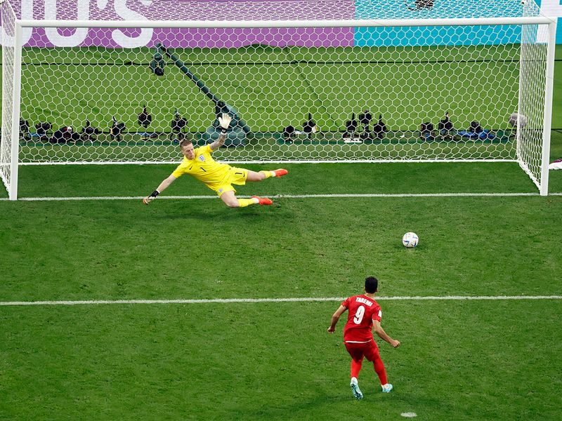 Iran's Mehdi Taremi scores their second goal from the penalty spot
