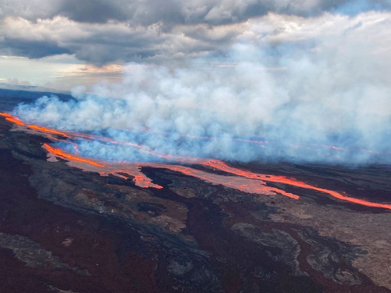 In this aerial photo released by the U.S. Geological Survey, the Mauna Loa volcano is seen erupting from vents on the Northeast Rift Zone on the Big Island of Hawaii, Monday, Nov. 28, 2022. Hawaii's Mauna Loa, the world's largest active volcano, began spewing ash and debris from its summit, prompting civil defense officials to warn residents on Monday to prepare in case the eruption causes lava to flow toward communities. 