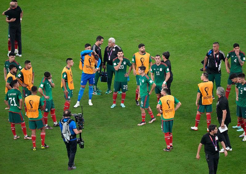 Mexico's players gather on the pitch after the World Cup group C 