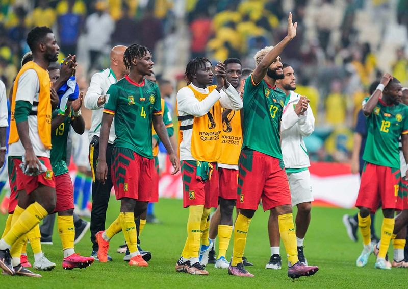 Cameroon players gesture to supporters at the end of the World Cup group G 