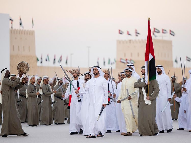 Lt General Sheikh Saif bin Zayed Al Nahyan, UAE Deputy Prime Minister and Minister of Interior (C), performs a traditional Al Ayyala dance during the Sheikh Zayed Heritage Festival. Seen with Sheikh Khalifa bin Tahnoun Al Nahyan, Executive Director of the Martyrs' Families' Affairs Office, and Sheikh Diab bin Tahnoon bin Mohamed Al Nahyan. 