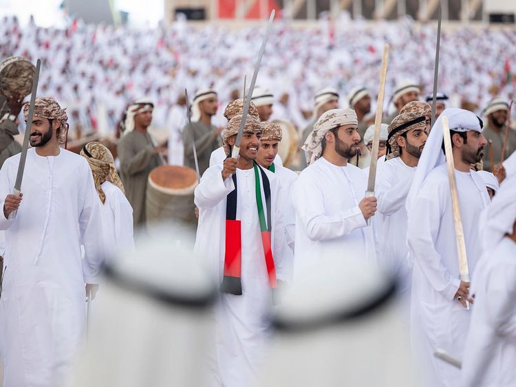 Sheikh Zayed bin Mohamed bin Hamad bin Tahnoon Al Nahyan (center L), and Sheikh Zayed bin Khalifa bin Sultan Al Nahyan (center R), perform a traditional Al Ayyala dance during the Sheikh Zayed Heritage Festival. 