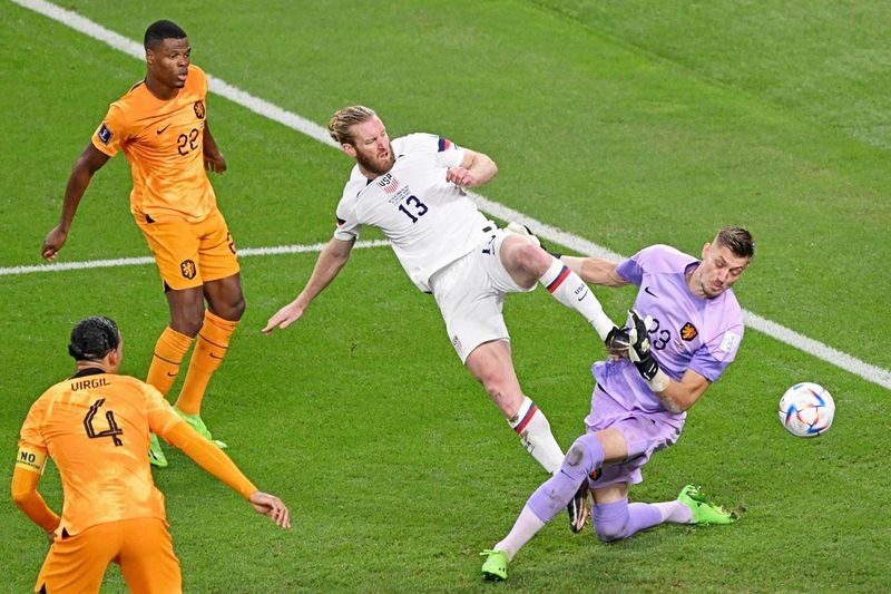 USA's defender #13 Tim Ream tries to score past Netherlands' goalkeeper #23 Andries Noppert during the Qatar World Cup round of 16 match at Khalifa International Stadium in Doha on December 3, 2022. 
