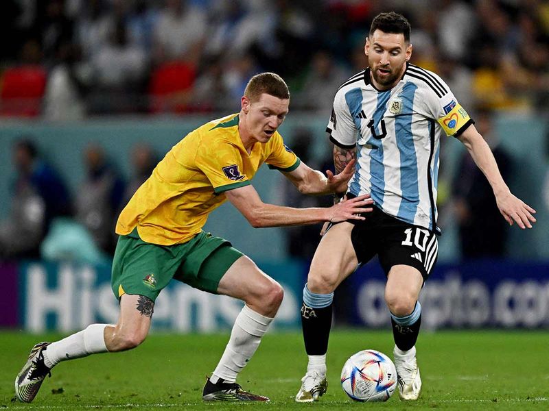 Argentina's Lionel Messi (right) is challenged by Australia's defender Kye Rowles