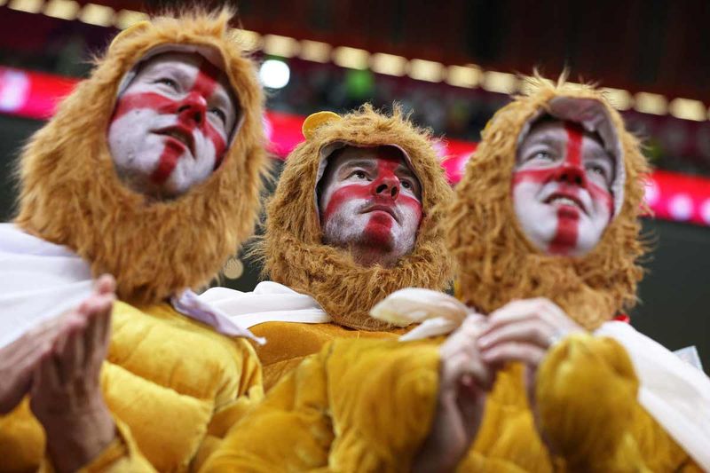 England supporters dressed in lion costumes wait for the start of the Qatar World Cup round of 16 match with Senegal at the Al Bayt Stadium in Al Khor, north of Doha. 