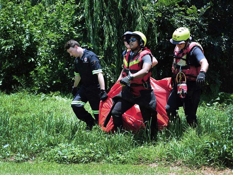 Rescuers carry the body of a flood victim that was retrieved from the Jukskei river in Johannesburg. 