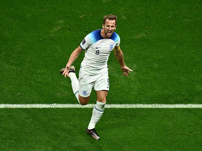 England's forward Harry Kane celebrates scoring his team's second goal during the Qatar World Cup round of 16 match against Senegal at the Al Bayt Stadium in Al Khor, north of Doha. 