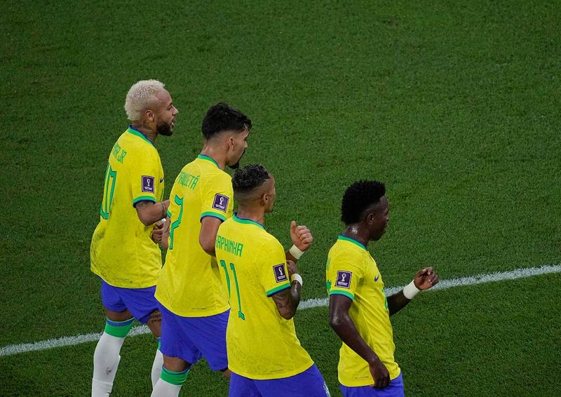 Brazil's Neymar, left, celebrates after scoring his side