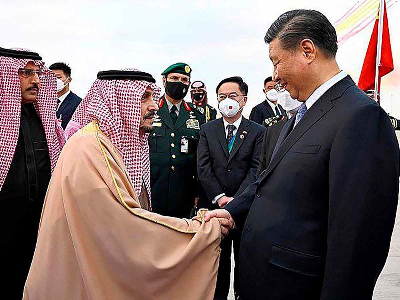 Chinese President Xi Jinping, right, shakes hands with Prince Faisal bin Bandar bin Abdulaziz