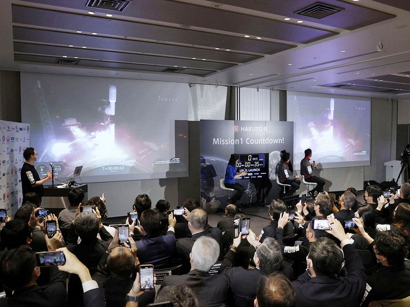 Officials of ispace Inc's HAKUTO-R mission look at live broadcasting of the launch of a SpaceX Falcon 9 rocket for ispace at Cape Canaveral Space Force Station, in Tokyo, on Sunday December 11, 2022. 