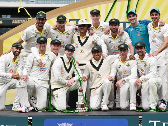 The Australian team pose with the trophy 
