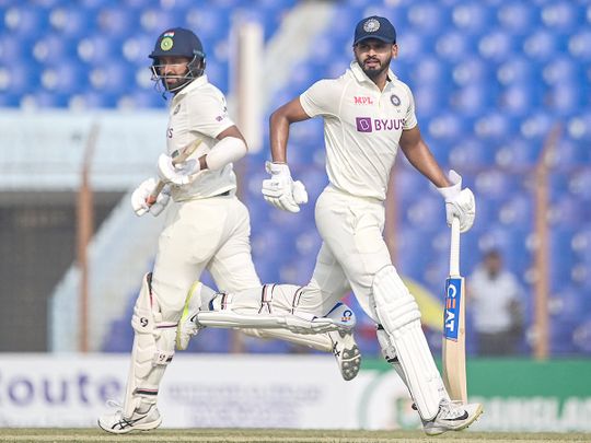 India's Shreyas Iyer (R) and Cheteshwar Pujara run between the wickets 