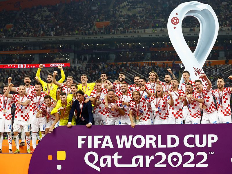 Croatia coach Zlatko Dalic and players celebrate with their medals on stage as they finish in third place. 