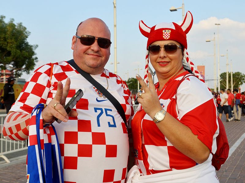 Croatia fans pose outside the Khalifa International Stadium in Doha before the match. 