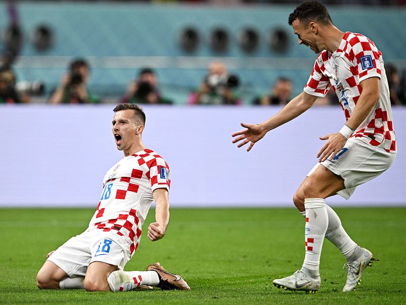 Croatia's forward Mislav Orsic (L) celebrates with  midfielderIvan Perisic after scoring his team's second goal. 