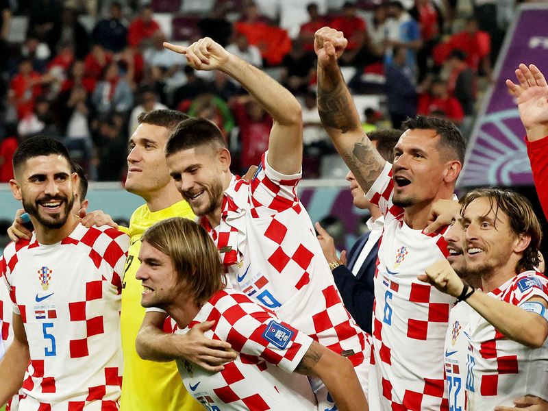 Croatia's players celebrate after winning the Qatar World Cup third place play-off football match against Morocco at Khalifa International Stadium in Doha on December 17, 2022. 