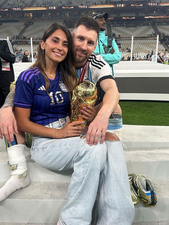 Argentina's Lionel Messi sits with his wife Antonela Roccuzzo after Argentina won the World Cup final soccer match against France at the Lusail Stadium in Lusail, Qatar, Sunday, Dec. 18, 2022. 