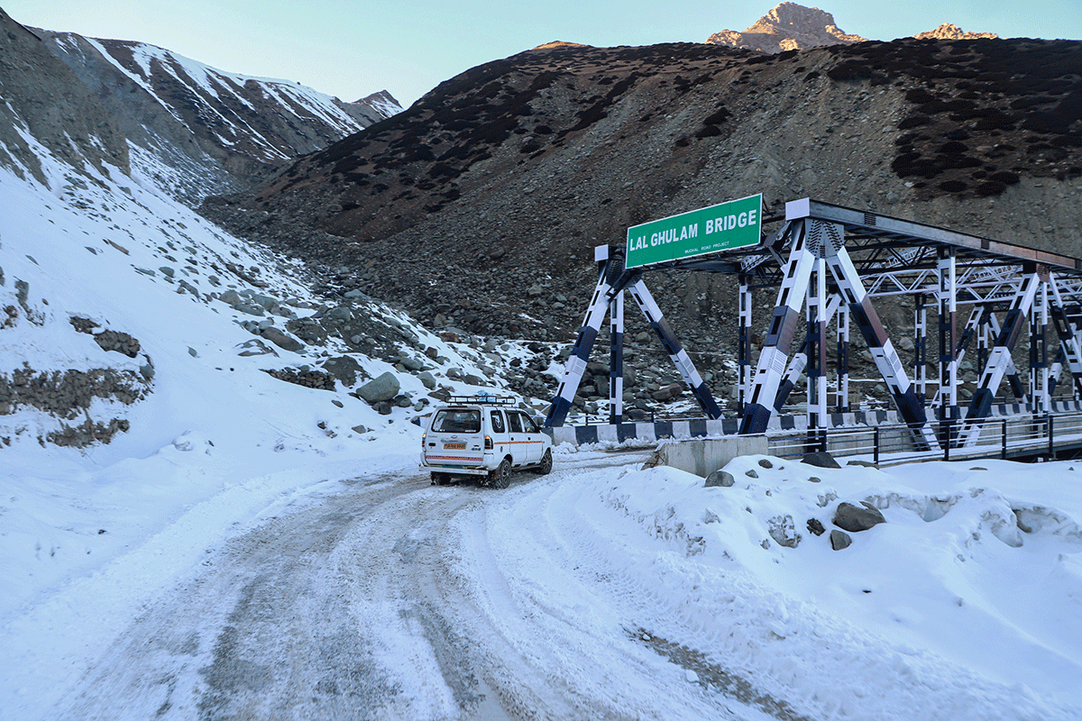 A vehicle plying on the snow-bound Lal Ghulam Bridge on Mughal Road that connects Shopian district in South Kashmir to Poonch district, in Rajouri on Thursday. 