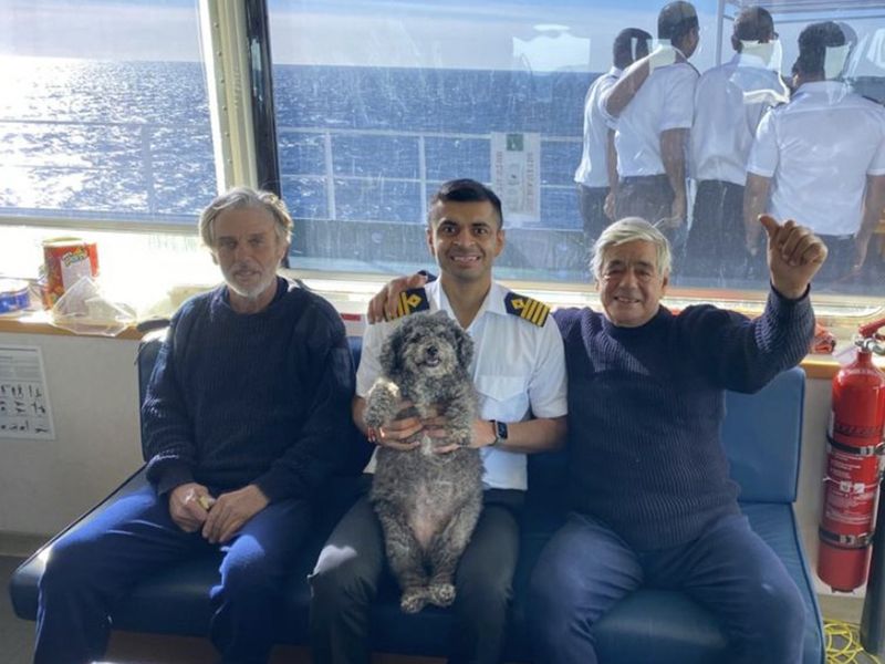 Capt Neeraj Chaudhary poses for a picture with Kevin Hyde (left) and Joe DiTomasso (right) and the dog Minnie.